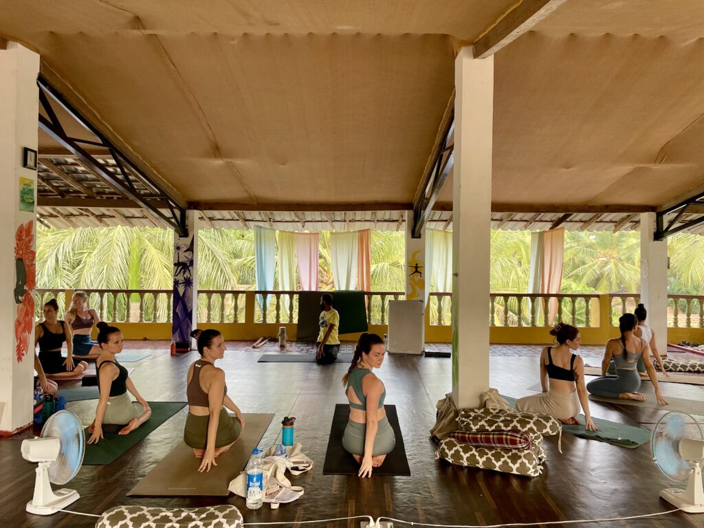 Students practicing yoga together in the shala at Ruh Yoga in Goa