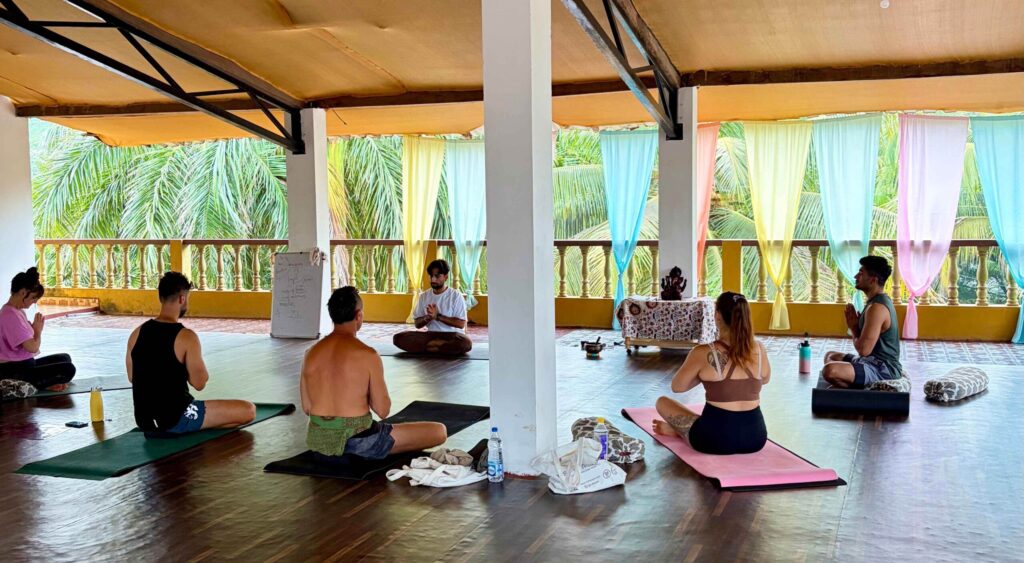 Students practising yoga at a teacher training in Agonda, Goa